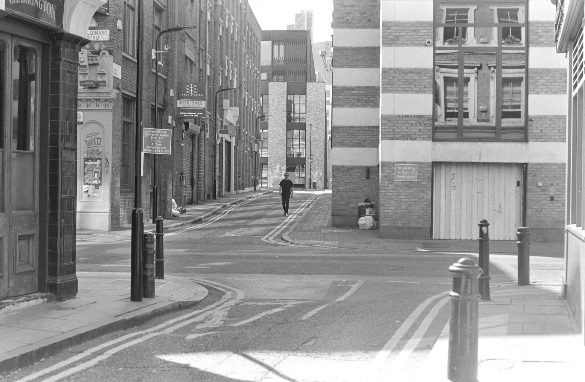 A lone figure walking down a quiet London street